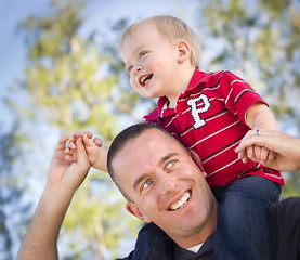Image showing Young Laughing Father and Child Piggy Back