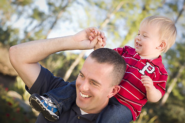 Image showing Young Laughing Father and Child Piggy Back