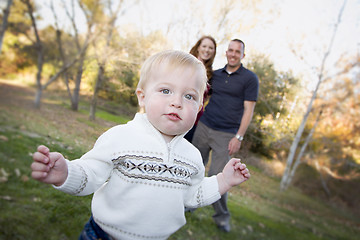 Image showing Cute Young Boy Walking as Parents Look On From Behind