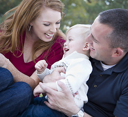 Image showing Attractive Young Parents Laughing with Child Boy in Park