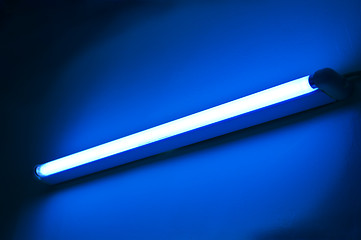 Image showing Fluorescent lamp shining on blue colored wall