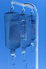 Image showing Shaded three infusion bottles hanging