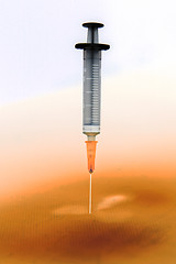 Image showing Shaded medical syringe standing head down