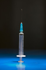 Image showing Ready medical syringe standing head up