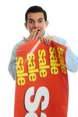 Image showing Retail shopkeeper with sale sign, 