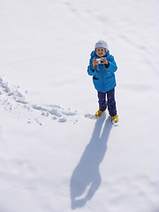 Image showing Young girl with photocamera on the snow field