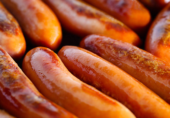 Image showing Sausages frying 