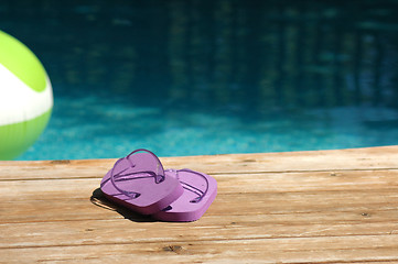 Image showing Purple sandles at pool