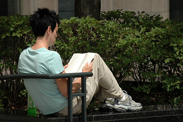 Image showing Woman reading in park