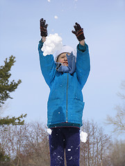 Image showing Young girl playing with snow