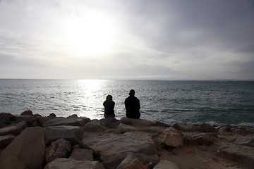 Image showing Two girls sit on the beach