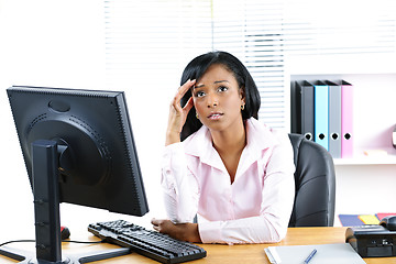 Image showing Worried black businesswoman at desk