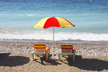 Image showing Beach chairs and umbrella