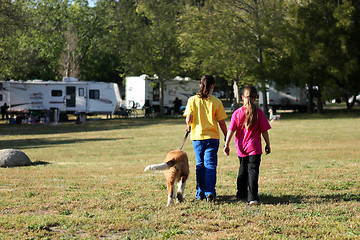 Image showing Girls Walking a Dog While Camping 