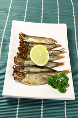 Image showing sprats with lemon