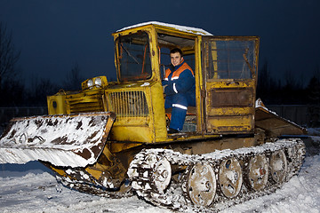 Image showing Tractor clearing snow at night