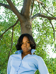 Image showing Pouting African American Woman Leaning Tree