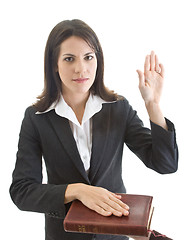 Image showing Caucasian Woman Swearing on a Bible Isolated White Background