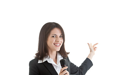 Image showing Caucasian Woman Holding Microphone Pointing Behind White Backgro