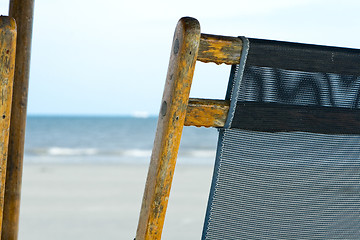 Image showing Back of a Weathered Mesh Beach Chair with Ocean Background.