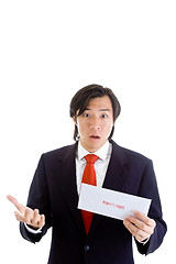 Image showing Shocked Asian Man Holding a Foreclosure Notice Envelope Isolated