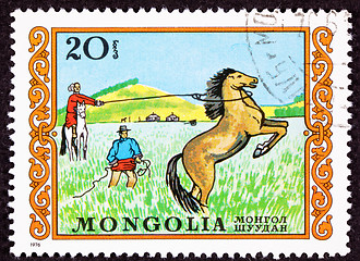 Image showing Canceled Mongolian Postage Stamp Men Capturing Lassoing Wild Hor