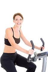 Image showing Happy White Woman Riding Exercise Bike Isolated Background
