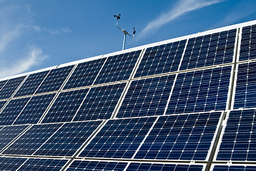 Image showing PV Solar Panel Array Against Blue Sky Anemometer