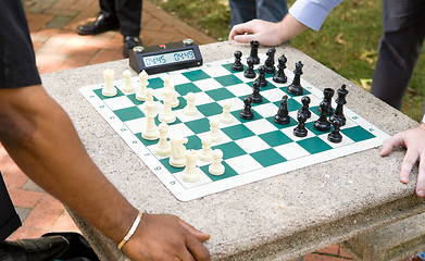 Image showing Two Players Play Timed Chess Game in a Park 
