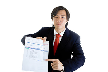 Image showing Serious Asian Businessman Pointing to Past Due Medical Bill Isol