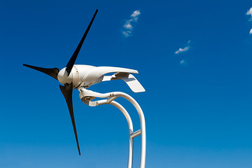 Image showing Home Sized Windmill Wind Turbine Isolated on Blue Sky        