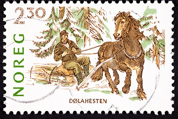 Image showing Canceled Norway Postage Stamp Dales Pony Pulling Man Log, Snow