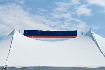 Image showing Banner Between Two Tent Poles Blue Sky