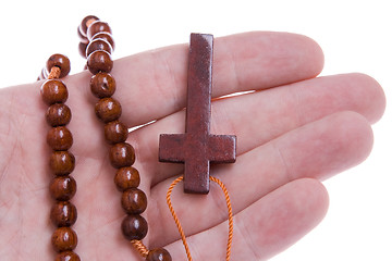 Image showing Hand Holding a Wooden Rosary Cross Isolated