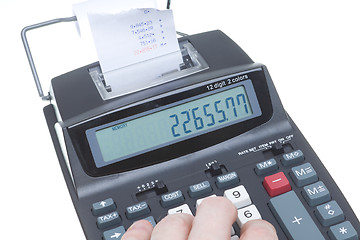 Image showing Hand Using Adding Machine, LCD, Tape, Isolated