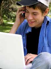 Image showing Teenager with a laptop and cellular
