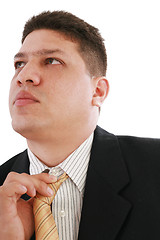 Image showing Business man fixing his tie, isolated over white 