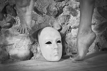 Image showing Female feet above a mask