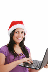 Image showing Beautiful business woman is working in office in santa claus hat