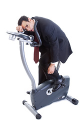 Image showing Exhausted Businessman on Exercise Bike Isolated White Background