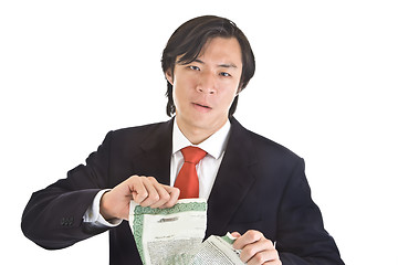 Image showing Unhappy Asian Man Tearing Stock Certificate, Isolated White Back
