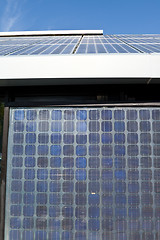 Image showing Rows of PV Solar Panels Mounted on Roof Blue Sky 