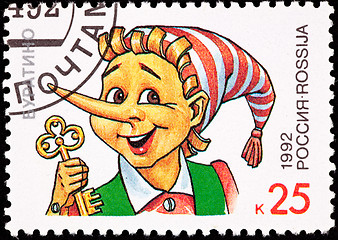 Image showing Canceled Russian Postage Stamp Pinocchio Puppet Holding Gold Key