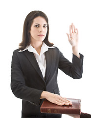 Image showing Caucasian Woman Swearing on a Bible Isolated White Background