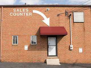 Image showing Arrow and Words Brick Wall Point to Sales Counter