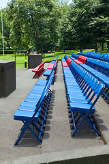 Image showing XXXL Rows of Blue Red Metal Folding Chairs Outside