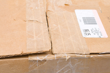 Image showing Worn Top Cardboard Package Box US Metered Mail