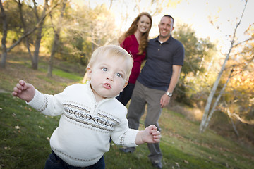 Image showing Cute Young Boy Walking as Parents Look On From Behind