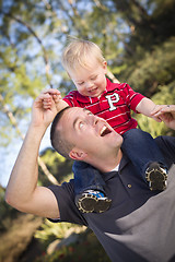 Image showing Young Laughing Father and Child Piggy Back