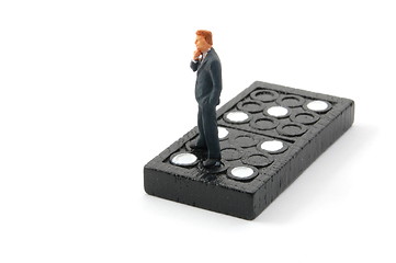 Image showing business man on domino isolated